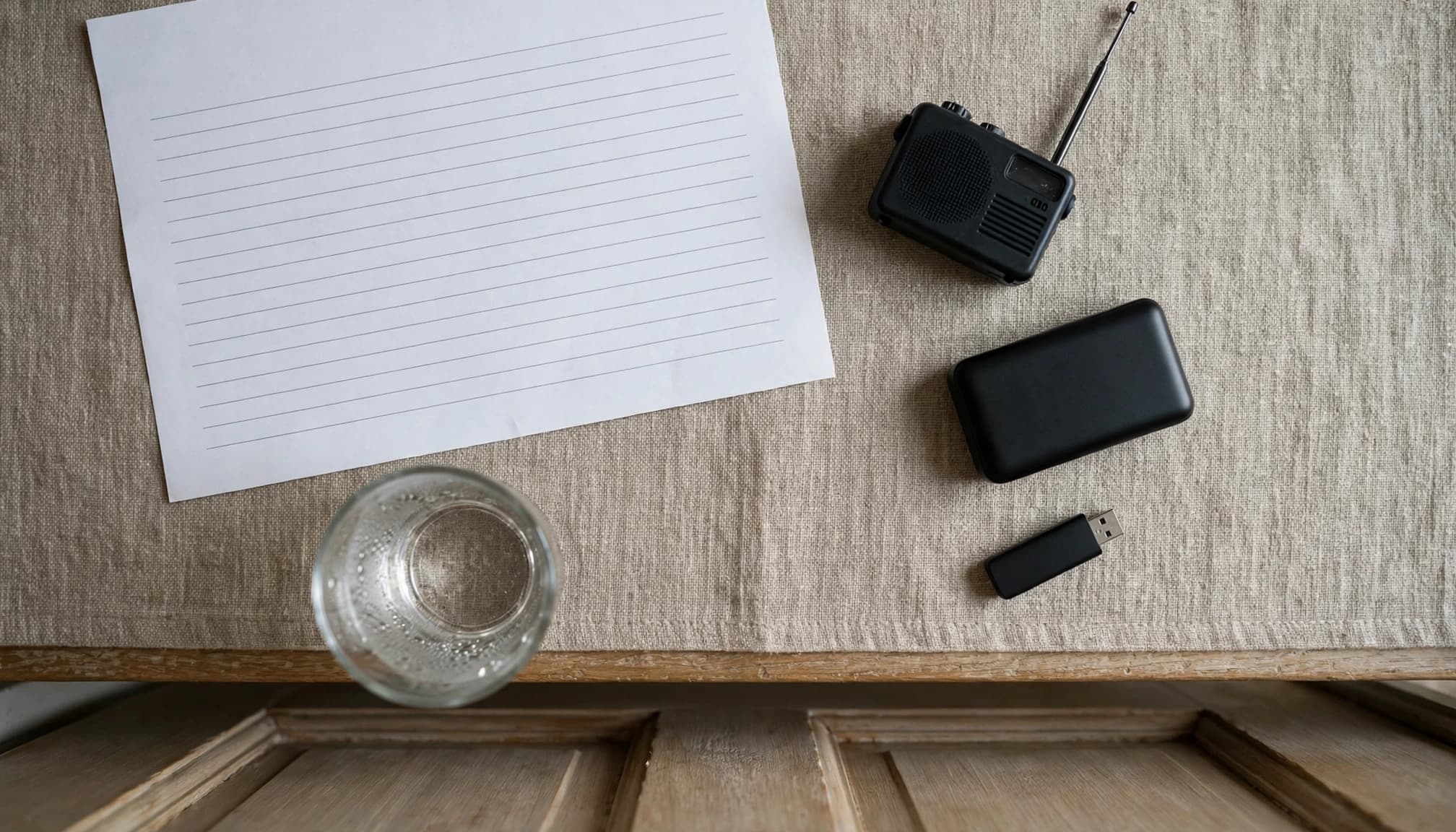 An emergency sheet and small backup supplies rest on a table by a closed door.