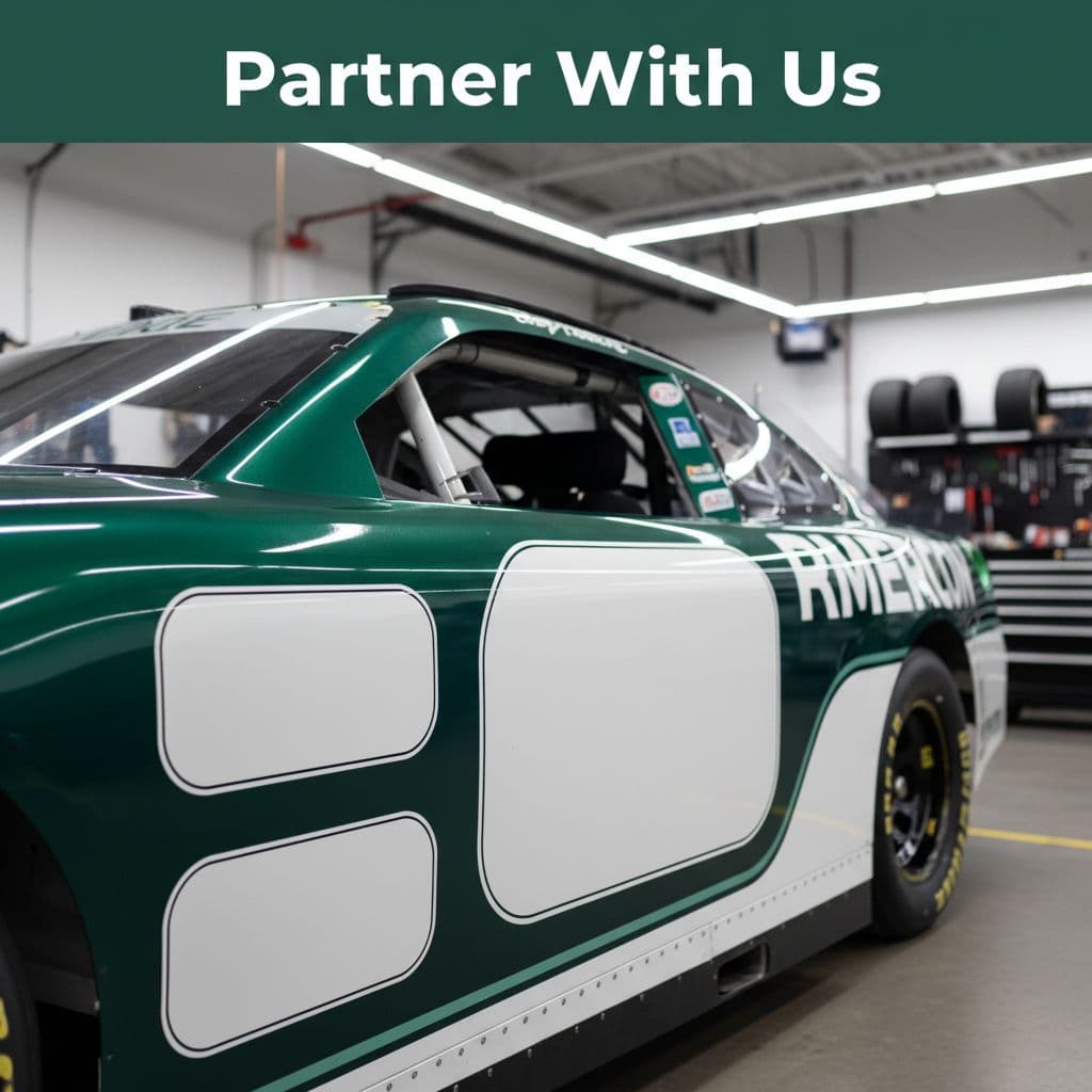 A close-up view of a professional race car body panel designed for sponsor placement inside a workshop.