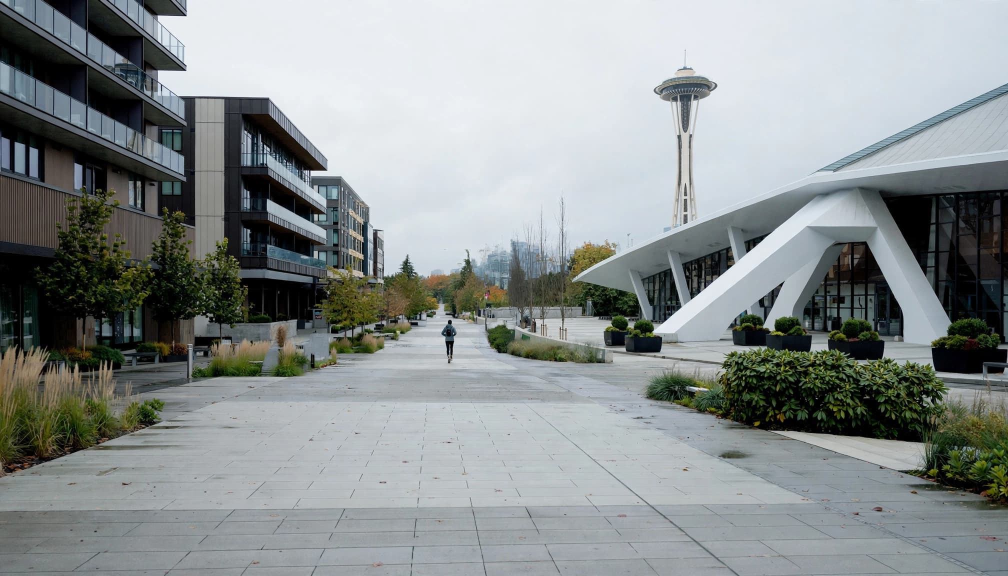One runner walks toward the Space Needle and Climate Pledge Arena on an overcast morning.
