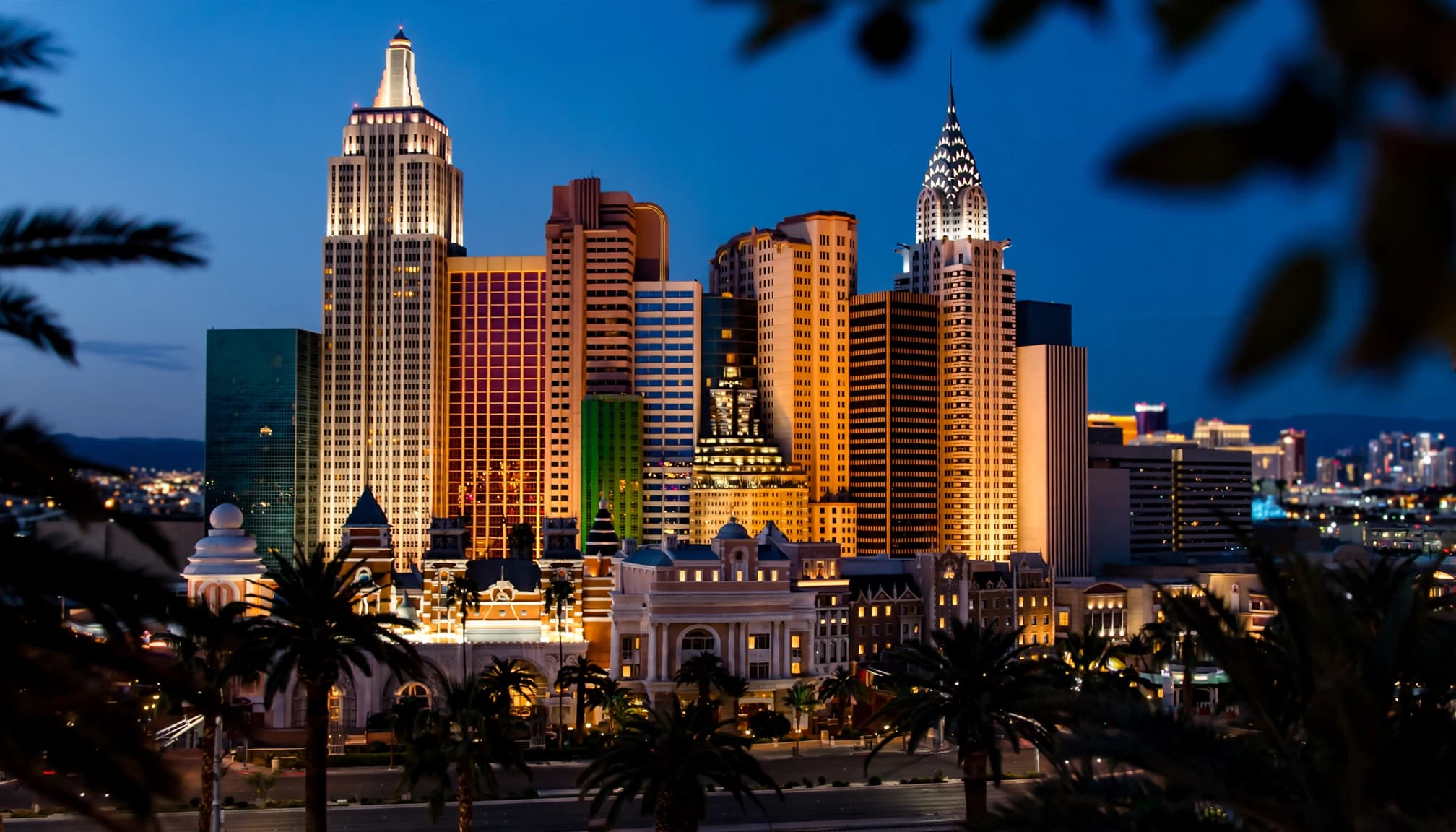 A wide view of the New York-New York resort skyline in Las Vegas at dusk.