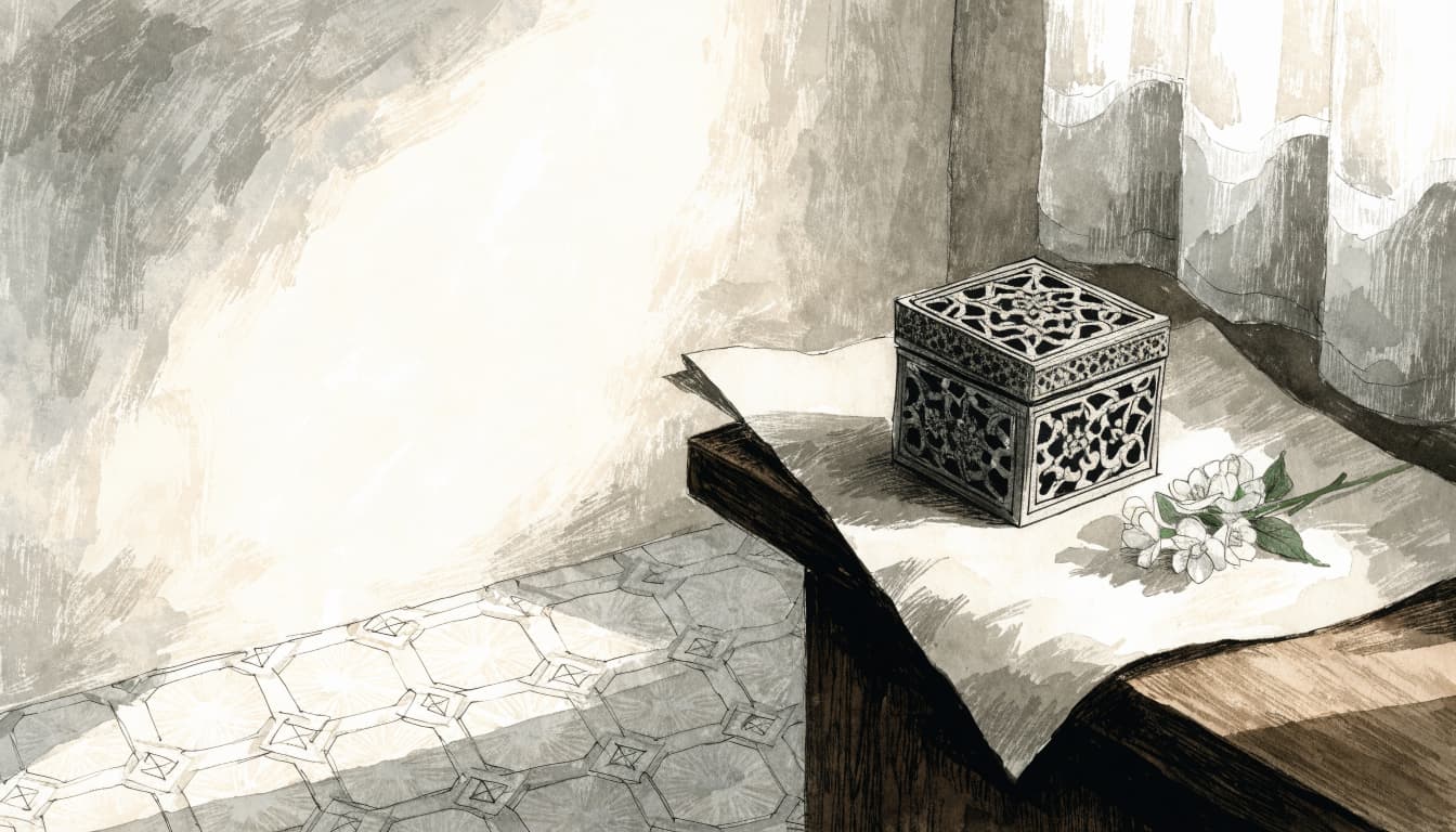 A closed ornate box, ivory paper, and jasmine sprig sit in warm light.