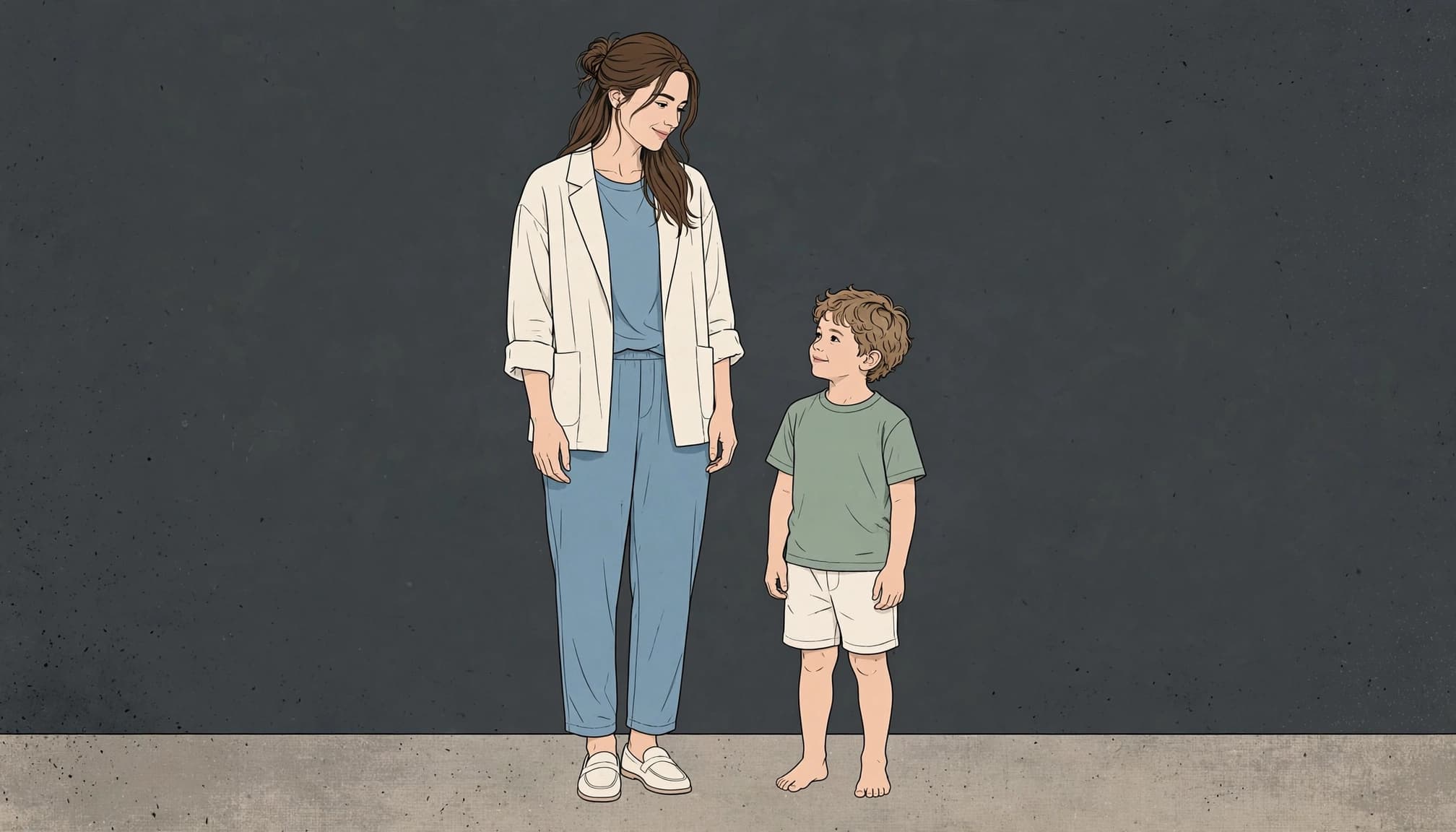 A mother and her barefoot son stand together in coordinated studio outfits.