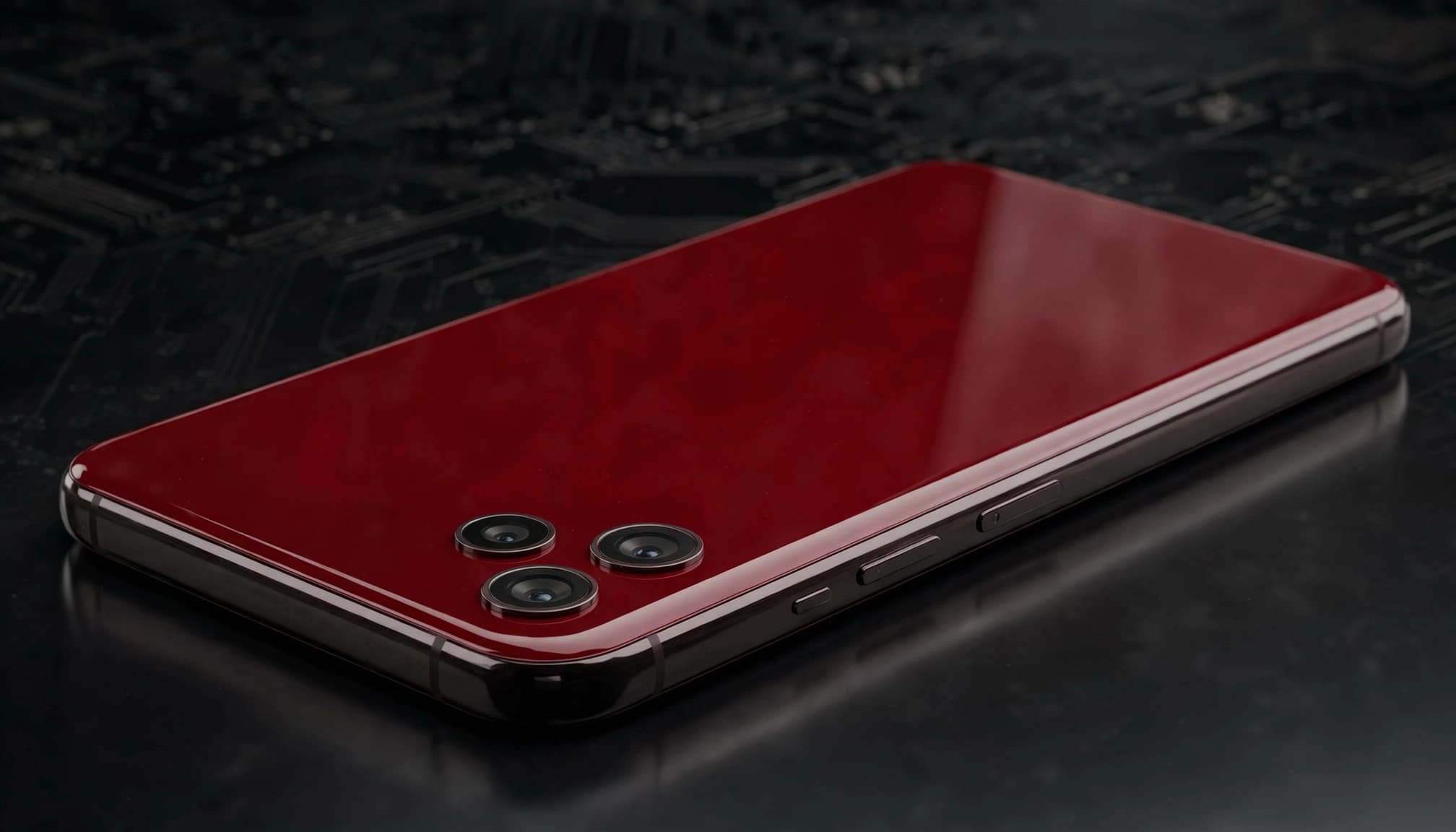 A deep red smartphone shown at an angle on a dark reflective surface.