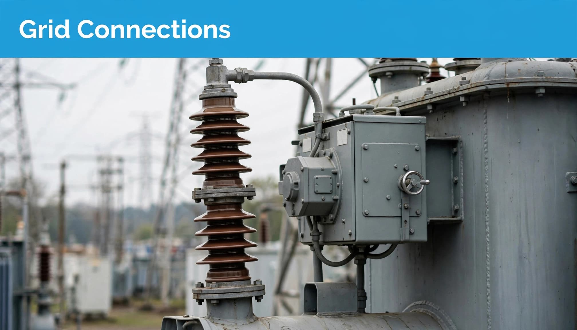 A transformer bushing and tap changer cabinet stand in an outdoor switchyard.