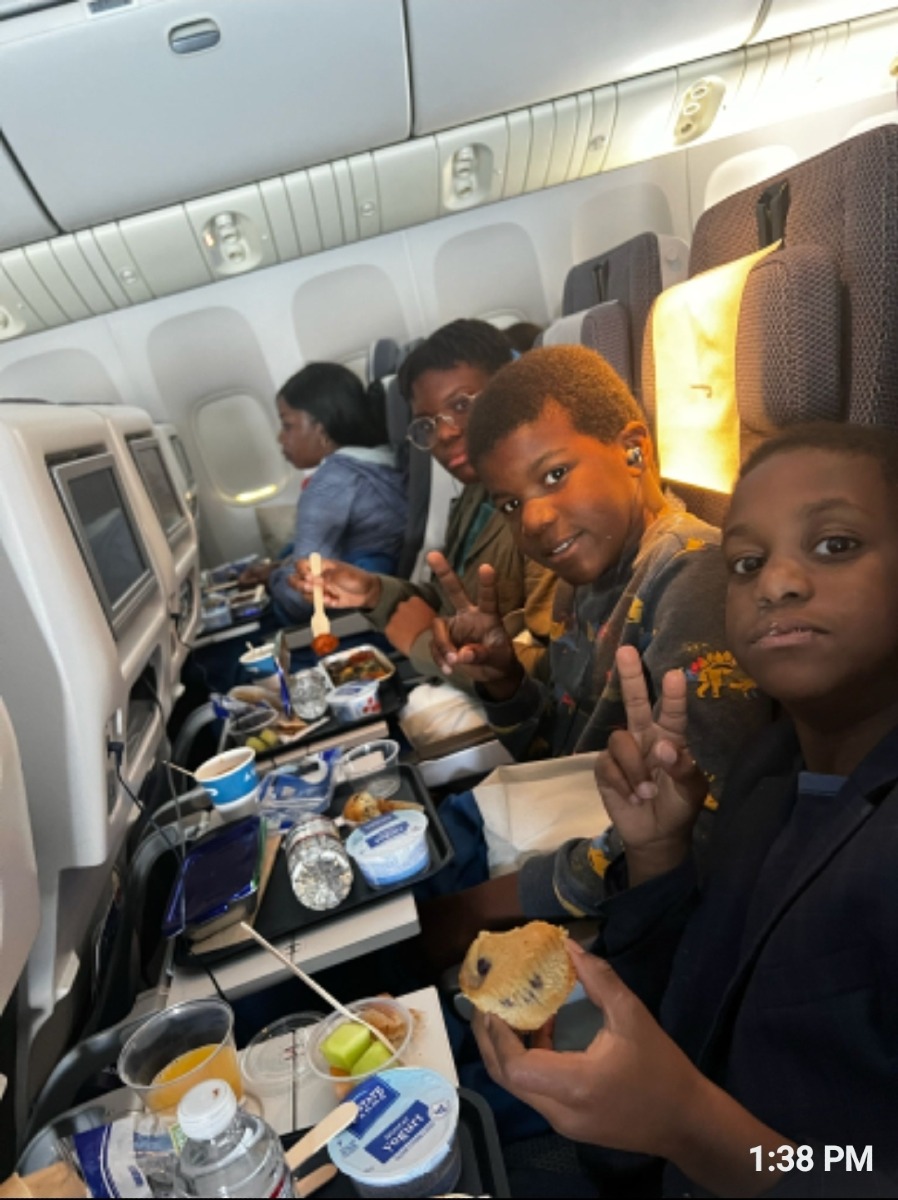 Children on the plane eating food on their way for summer holiday with their dad .Long distance visits